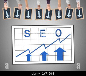 Hands holding writing slates with arrows pointing on seo concept Stock Photo