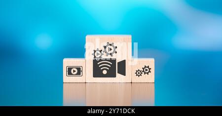 Wooden blocks with symbol of live streaming concept on blue background Stock Photo