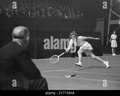 THE WIGHTMAN CUP AT WIMBLEDON .    Play in the Wightman Cup match between the women of Great Britain and of the U S A , began at Wimbledon .     PICTURE SHOWS :-Mrs JEAN BOSTOCK , a British house-wife ,  partnered by Mrs MOLLY BLAIR , seen in action against Mrs PAT TODD and Miss DORI HANT at wimbledon . This was the first time a British  ' Doubles' have gained a victory over America in the Wightman Cup since the war .    June 12 1948 Stock Photo