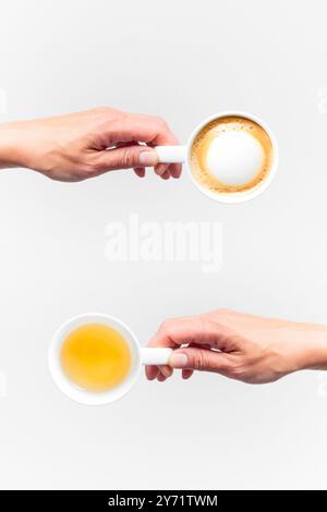 An white ceramic cups with tea and coffee in a female hands on a white background, top view collage Stock Photo