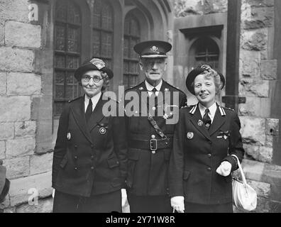 St John's Investiture   Members of the St John Ambulance Brigade from all over the country attended an investiture at St John's Gate, Clerkenwell, headquarters of the Brigade.     Picture shows : (Left to right) - Miss Hetty Perrett, of Bath (Serving Sister); Mr Samuel John Bailey, of Weston-super-Mare (Officer Brother) and Miss Gladys Dandy, M.B.E. of Taunton Off icier Sister).    30 July 1948 Stock Photo