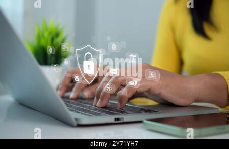 Cybersecurity and Global network security technology concept, Businesswoman protecting personal data on computer with virtual interface, Internet secu Stock Photo