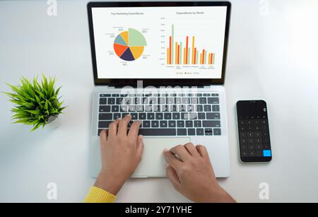 Top view of business financing accounting banking concept. Woman hand doing finances and calculate on desk about cost at home office. Woman working on Stock Photo