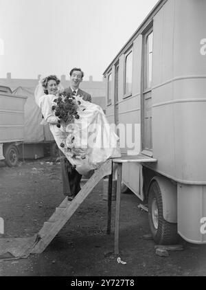 "Marry-Go-Round"   Fairground folk from all over England gathered at St James's Church, Bermondsey, today (Monday) at the wedding of 28-year-old Emily Rawlins, who runs a skittle alley, and George Lorenzo Crick, 29, who operates a spinning wheel. The couple will live in a new three roomed caravan.      March 1st 1948 Stock Photo