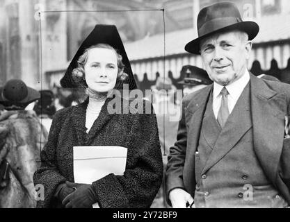 The King opens Parliament. Following the opening of Parliament by the King this morning (Tuesday), His Majesty, accopanied by the Queen driving in State from the House of Lords back to Buckingham Palace. In the carriage immediately behind the Kings, and taking part in the ceremony for the first time, drove Princess Elizabeth.  Photo shows, Lord and Lady Howe , pictured after they had attended this morning ceremony at Westminster. Lady Howe is wearing an unusual tricorn hat with a Persian lamb coat.  21 October 1947 Stock Photo