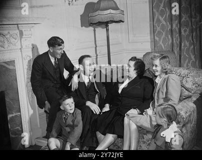 New Australian Minister at home. the new Australian Resident Minister in London, mr J A Beasley, who arrived in this country with his family yesterday, has taken up home life at the official residence of the Australian High Commissioner at Ennismore gardens, Knightsbridge.  Picture shows, fireside scen at Ennismore Gardens, left to right 17 year old John, Mr J A Beasley, Mrs Beasley and 16 year old June. the two youngest members of the family are in front James who is 7 years old and 10 year old Jill.  24 January 1946 Stock Photo