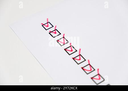 checkboxes with red marking on checklist on white paper Stock Photo