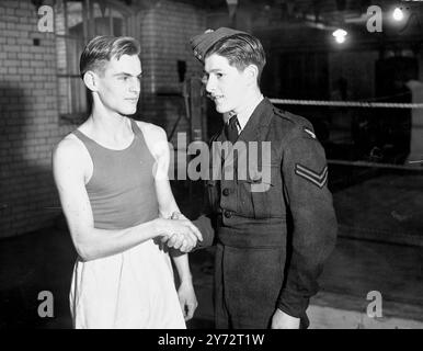 The team of Swiss amateur boxers who arrived in the country yesterday and who meet Great Britain at the Empire pool, Wembley, were busy this morning at Scotland Yard gymnasium at Cannon Row Police Station. The Swiss boxers have been invited to use the gymnasium for a last-minute tuning up for tomorrow night. Picture shows: The two Fly Weights who will meet each other are remarkably alike in both face and built they are : H. Jolivet, Switzerland (left) and Cpl. Les Daw  of the RAF photographed at the gymnasium.   10 December 1946 Stock Photo