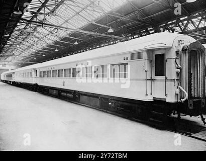 Eight of the 14 coaches which will comprise the 'White Train', to be used by their majesties and the Princess during their tour of South Africa next year, have been completed at the Metro-Cammell works at Birmingham. Five of these coaches are saloons of special designed to accommodate the King and Queen, the princesses, Royal household staff, and South African Government Ministers and staff. The coaches are fully air-conditioned, fitted throughout with safety glass, and will afford almost silent travel. Picture shows: A line of four completed coaches of the 'White Train' in the paint shop, com Stock Photo