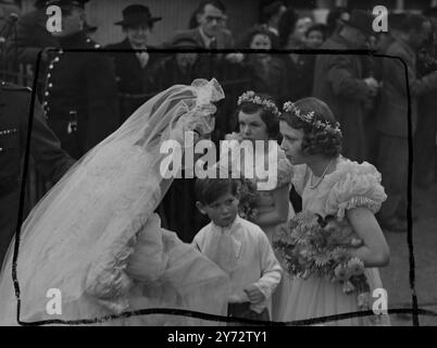 Members of the Royal family were present at St Margaret's, Westminster when Miss Myra Wernher, daughter of Sir and Lady Harold Wernher, was married to Maj David Butter, M.C., the Scots Guards. In attendance on the bride with Princess Alexandra of Kent and her young brother Prince Michael. Picture shows: After her wedding the bride stopped to speak to her bridal attendants as she left the church.  5 November 1946 Stock Photo