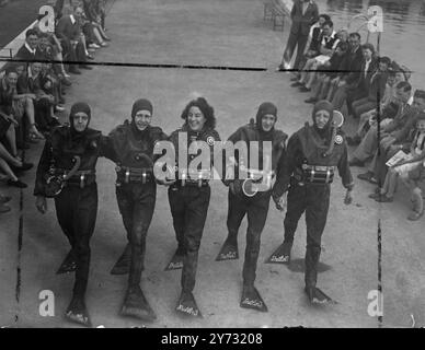 'Frogmen' the underwater swimmers used for daring operations during the war, have trained a 'frogwoman' to assist them in their demonstration of this type of all work at Butlins holiday camp at Filey, Yorkshire. She is Gwenda Davies,  25 years old ex-Waaf and one-time insurance clerk.  Left to Right:- John Kassell, J.G.I Marriot, Gwenda Davies and 'Chuck' Leyland.   28 June 1946 Stock Photo