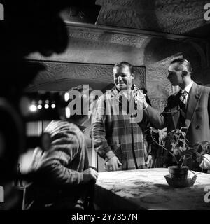 Ealing Studios. The filming of the British thriller, The Siege of Pinchgut at Ealing Studios.  Photo shows ;  Film technician taking a light reading before filming a scene with US actor , Aldo Ray.  1958 Stock Photo