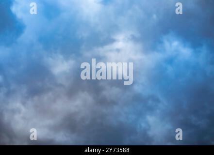 A dramatic sky, colorful sky, before storm and during sunset. Huge clouds formations. Stock Photo