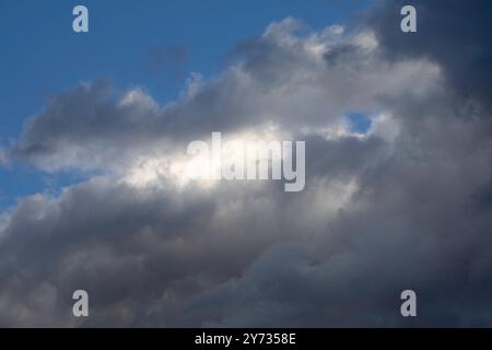 A dramatic sky, colorful sky, before storm and during sunset. Huge clouds formations. Stock Photo
