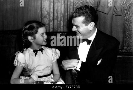 Mandy at the Premiere. Screen star Jack Hawkins, chatting with child actress Mandy Miller at the world premiere of ''The Titfield Thunderbolt'', screened at the Leicester Square Theatre.  The premiere was preceded by the presentation of the British Film Academy 1952 Awards.  5 March 1953 Stock Photo