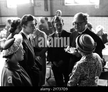 In order to save his parishioners a lot of walking from the outlying estates the Rev P Churton Collins has provided a bus service for his early services . In addition , breakfasts are also served in the church hall after the service . He is seen here chatting informally with his congregation . 24 May 1959 Stock Photo