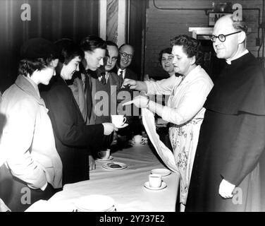 In order to save his parishioners a lot of walking from the outlying estates the Rev P Churton Collins has provided a bus service for his early services . In addition , breakfasts are also served in the church hall after the service . He is seen here chatting informally with his congregation . 12 May 1959 Stock Photo