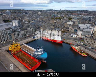 Aerial view from drone of ships in harbour and city skyline in Aberdeen Port, Aberdeenshire, Scotland, UK Stock Photo