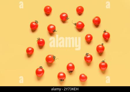 Frame made of fresh cherry tomatoes on yellow background Stock Photo