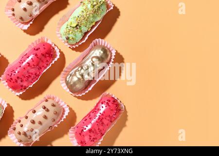 Composition with different glazed eclairs on color background Stock Photo