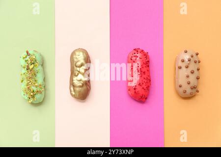 Composition with delicious glazed eclairs on color background Stock Photo