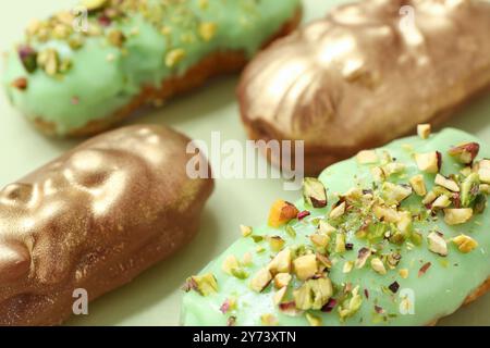 Tasty glazed eclairs on color background, closeup Stock Photo