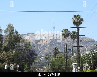 The Hollywood Sign, perched on the Hollywood Hills, symbolizes the global entertainment industry and the allure of Los Angeles' film and TV heritage. Stock Photo