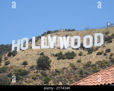 The Hollywood Sign, perched on the Hollywood Hills, symbolizes the global entertainment industry and the allure of Los Angeles' film and TV heritage. Stock Photo