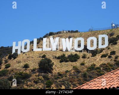 The Hollywood Sign, perched on the Hollywood Hills, symbolizes the global entertainment industry and the allure of Los Angeles' film and TV heritage. Stock Photo