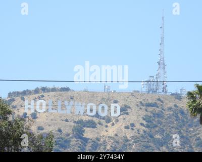 The Hollywood Sign, perched on the Hollywood Hills, symbolizes the global entertainment industry and the allure of Los Angeles' film and TV heritage. Stock Photo