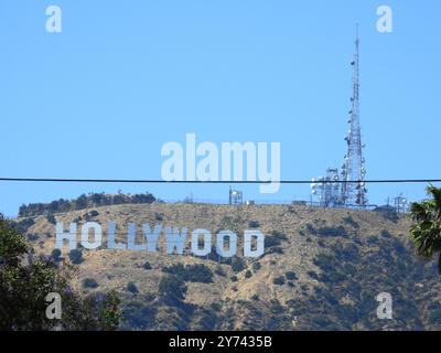 The Hollywood Sign, perched on the Hollywood Hills, symbolizes the global entertainment industry and the allure of Los Angeles' film and TV heritage. Stock Photo