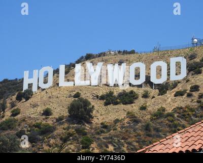 The Hollywood Sign, perched on the Hollywood Hills, symbolizes the global entertainment industry and the allure of Los Angeles' film and TV heritage. Stock Photo