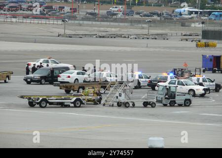 ChatGPT Police escort and emergency response at airport tarmac involving law enforcement vehicles and personnel near a Southwest Airlines plane in a Stock Photo