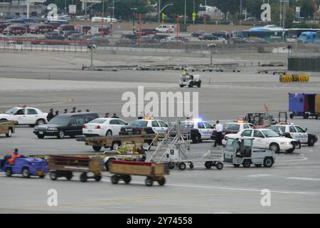 ChatGPT Police escort and emergency response at airport tarmac involving law enforcement vehicles and personnel near a Southwest Airlines plane in a Stock Photo