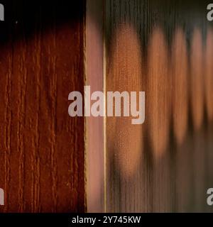 Sun Reflection from Blinds on Red-Brown Closet During Sunset – Pattern and Texture Stock Photo