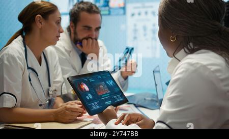 Medical team collaborates on diagnostic procedures and treatment plans. Professionals in radiology and radiography support accurate diagnosis and effective disease prevention, insurance. Camera B. Stock Photo