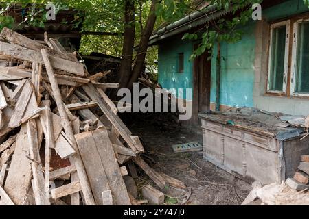 Abandoned House Surrounded by Nature and Timber Debris. Stock Photo