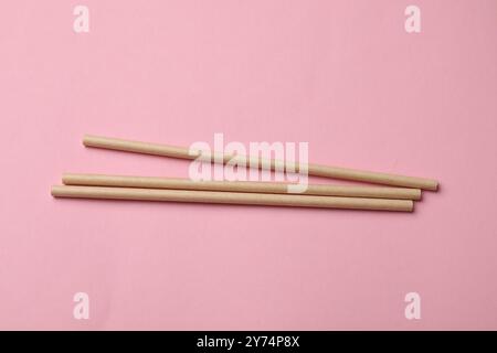 Bamboo drinking straws on pink background, top view Stock Photo