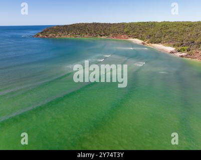 Aerial view of turquoise ocean around a river flowing out past sandy beaches at Pambula Beach in Southern New Southern Wales, Australia. Stock Photo