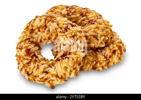 Closeup view pile of crispy homemade sweet rice crackers with cane sugar syrup isolated on white background with clipping path. Stock Photo