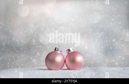 Beautiful pink Christmas balls, snowflakes on snow and winter background. Stock Photo