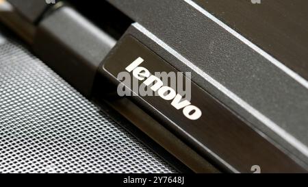 Lenovo company logo on a modern laptop computer, closeup detail, nobody. Lenovo brand corporation products symbol up close, no people, equipment, appl Stock Photo