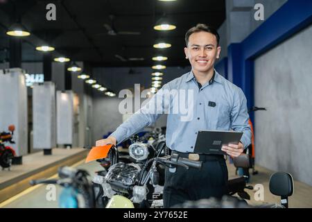 asian manager monitoring electric motorbike product Stock Photo