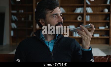 Successful serious Caucasian mature business man male businessman employer talking mobile phone saying smartphone using smart technologies dictate Stock Photo
