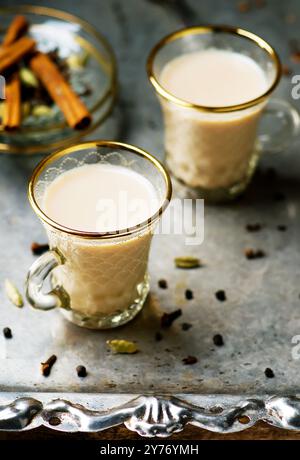 Indian masala tea in glass cups on a metal background. style vintage. selective focus Stock Photo