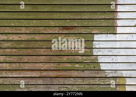 Wooden wall made of old boards painted green and white. Stock Photo