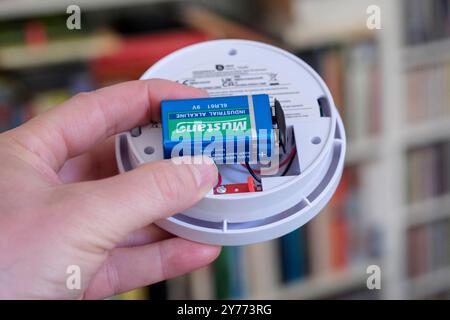 Changing the battery in a smoke detector Stock Photo
