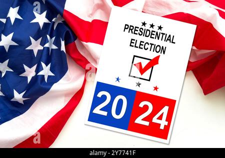 Politics and voting concept. Presidential election 2024 text on white paper over the American flag background Stock Photo