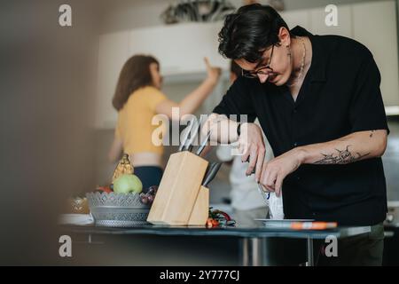 Man preparing food in a modern kitchen setting Stock Photo
