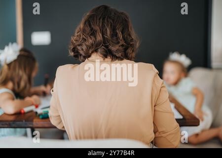 Mother spending quality time with daughters at home Stock Photo